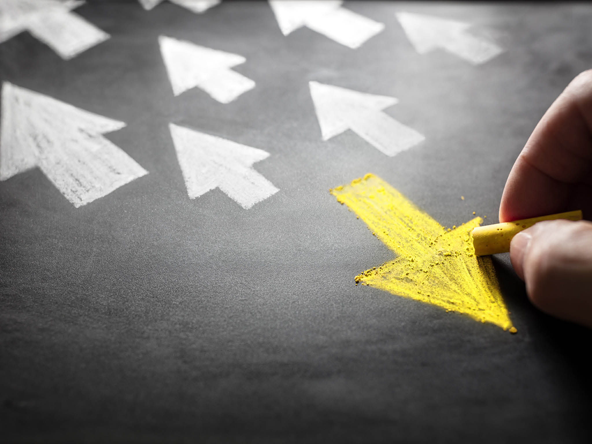 Individuality chalk arrow going a different direction on blackboard