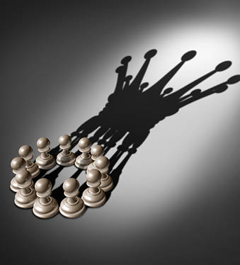 Business concept Leadership team and group concept as an organized company of chess pawn pieces joining forces and working together united and as one in agreement to cast a shadow shaped as a king crown 3D render. 