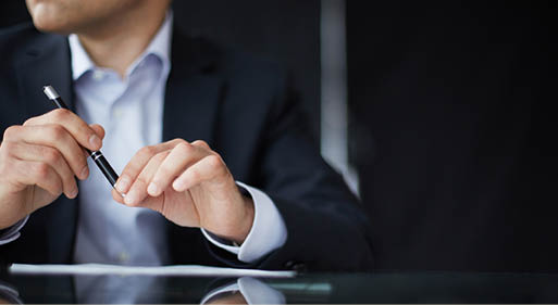 Close-up of male hands with pen