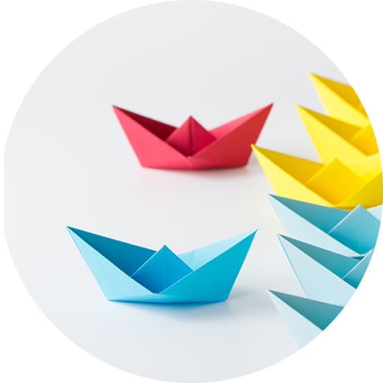 Business competition concept using two different color origami paper boats