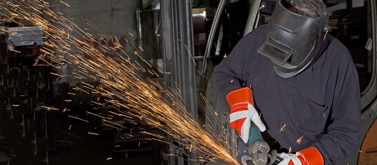 orange sparks during metal grinding in heavy industry plant