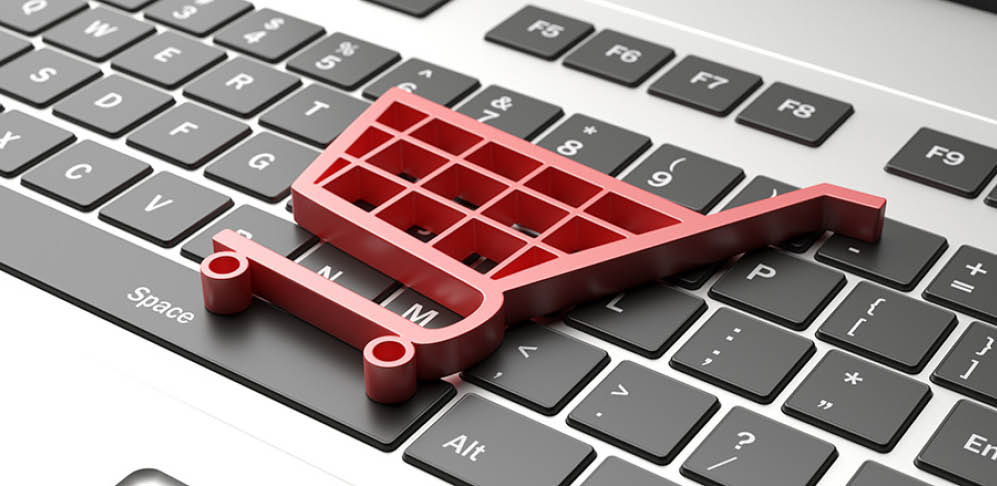 E shop, e commerce concept  Shopping cart trolley icon on a computer laptop  3d illustration