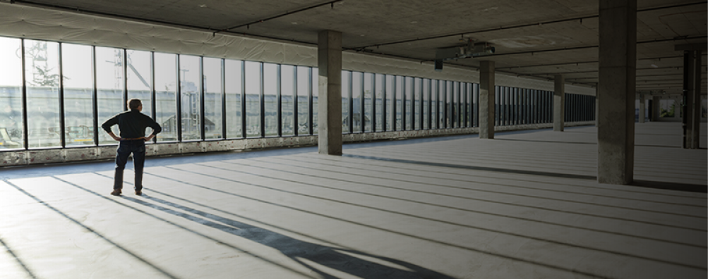 Single businessman in new empty raw business space for a new office