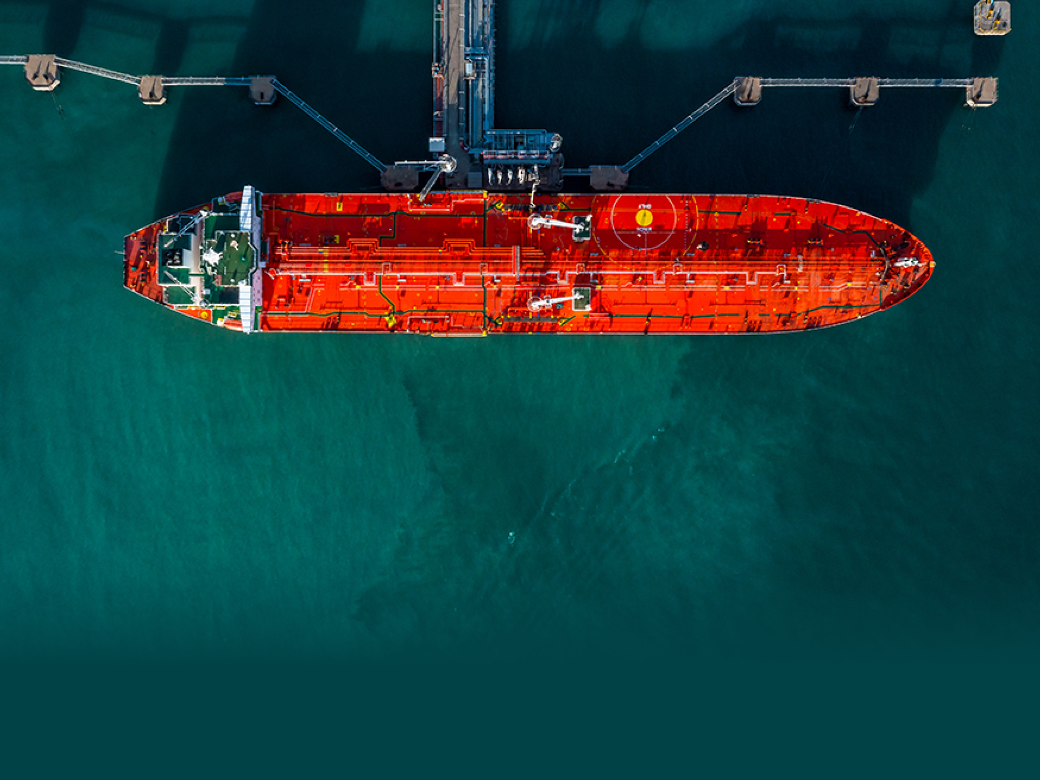 Aerial view tanker ship vessel unloading at port, Business import export oil and gas petrochemical with tanker ship transportation oil from dock refinery, Loading arm oil and gas offshore platforms.