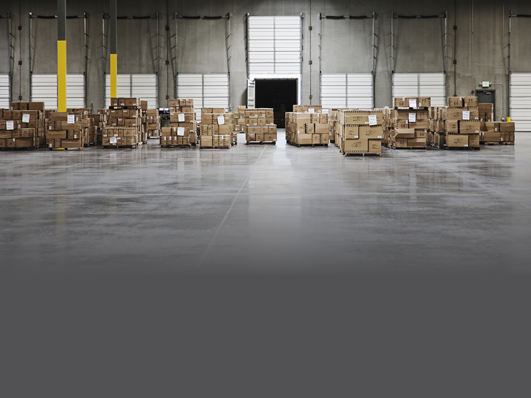 Cardboard boxes at loading dock in warehouse