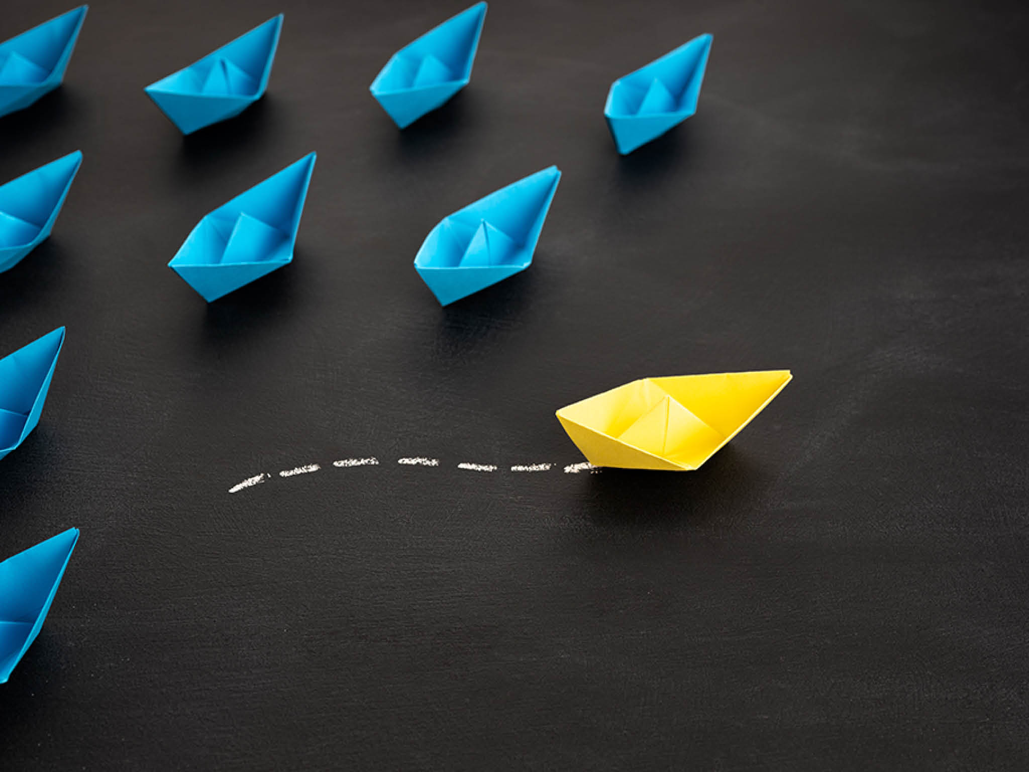 Leadership, unique or freedom concept. Yellow paper ship are different from others. Business for Innovative solution concepts