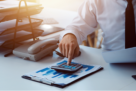 Close up of Business team analyzing income charts and graphs with modern laptop computer. Business analysis and strategy concept.